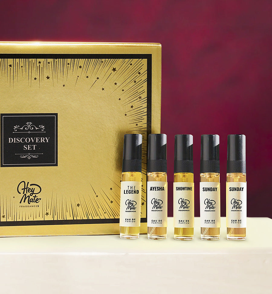 Set of perfume bottles with a gold box labeled 'Discovery Set' on a red background