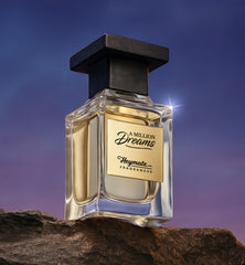 Perfume bottle labeled 'A Million Dreams' by Heymata Fragrances on a rock with a dark blue sky background.