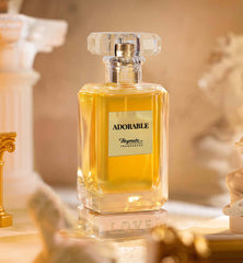 Perfume bottle labeled 'Adorable' by Heymata Fragrances on a decorative background