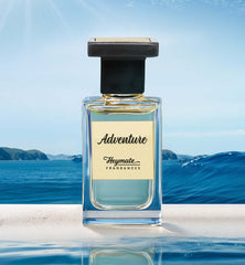 Perfume bottle labeled 'Adventure' by Heymate Fragrances with a scenic background of water and sky.