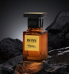 BOSS Pour Homme perfume bottle on a dark, textured background