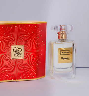 Perfume bottle and packaging with 'HeyMate' branding on a light gray background