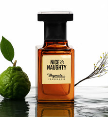 Orange perfume bottle labeled 'Nice & Naughty' by Heymate Fragrances inspired by sauvage dior with a green fruit and branch