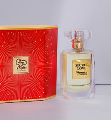 Perfume bottle labeled 'Secret Love' by Hey Mate Fragrances next to its red packaging box.