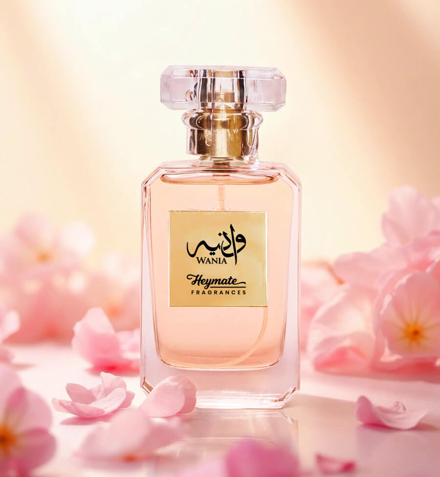 Perfume bottle with 'Wania' branding on a soft pink floral background