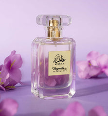Perfume bottle with gold cap and label on a purple background with flowers