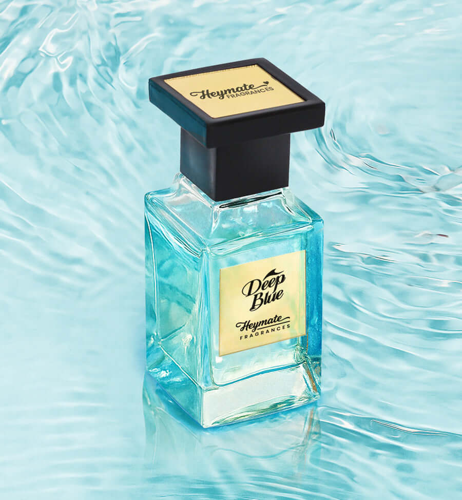 Perfume bottle labeled 'Deep Blue' by Heymate Fragrances on a water-themed background