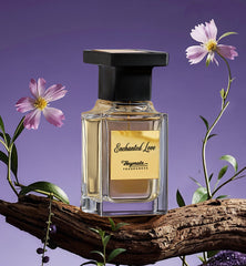 Perfume bottle labeled 'Enchanted Love' with flowers on a purple background