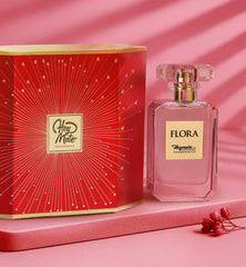 Flora perfume bottle with red packaging on a pink background