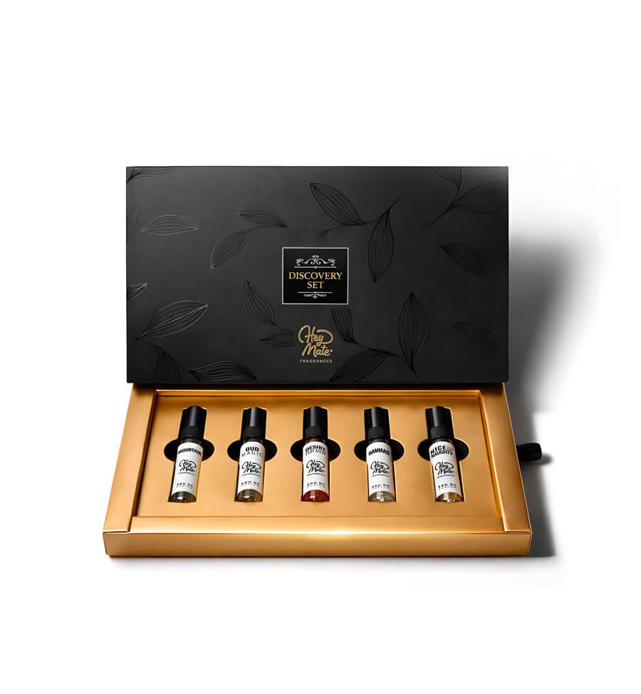 Set of five small bottles in a decorative black and gold box with 'Discovery Set - Heymate' branding.