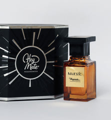 Perfume bottle labeled 'Majestic' by HeyMate Fragrances next to its packaging on a light gray background