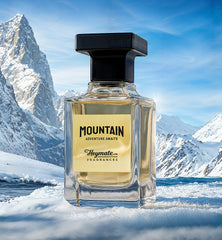 Perfume bottle labeled 'Mountain' by Heymate Fragrances against a snowy mountain backdrop