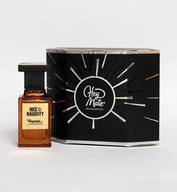 Perfume bottle labeled 'Nice & Naughty' by Hey Mate Fragrances next to its packaging on a white background.