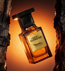 Perfume bottle labeled 'Oud Supreme' by Heymate Fragrances against a warm, wooden background.