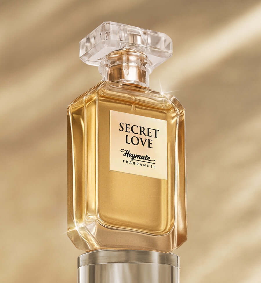 Perfume bottle labeled 'Secret Love' by Heymate Fragrances on a gold background